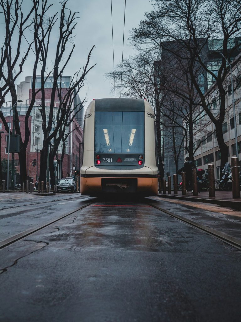 white and orange tram on road during daytime