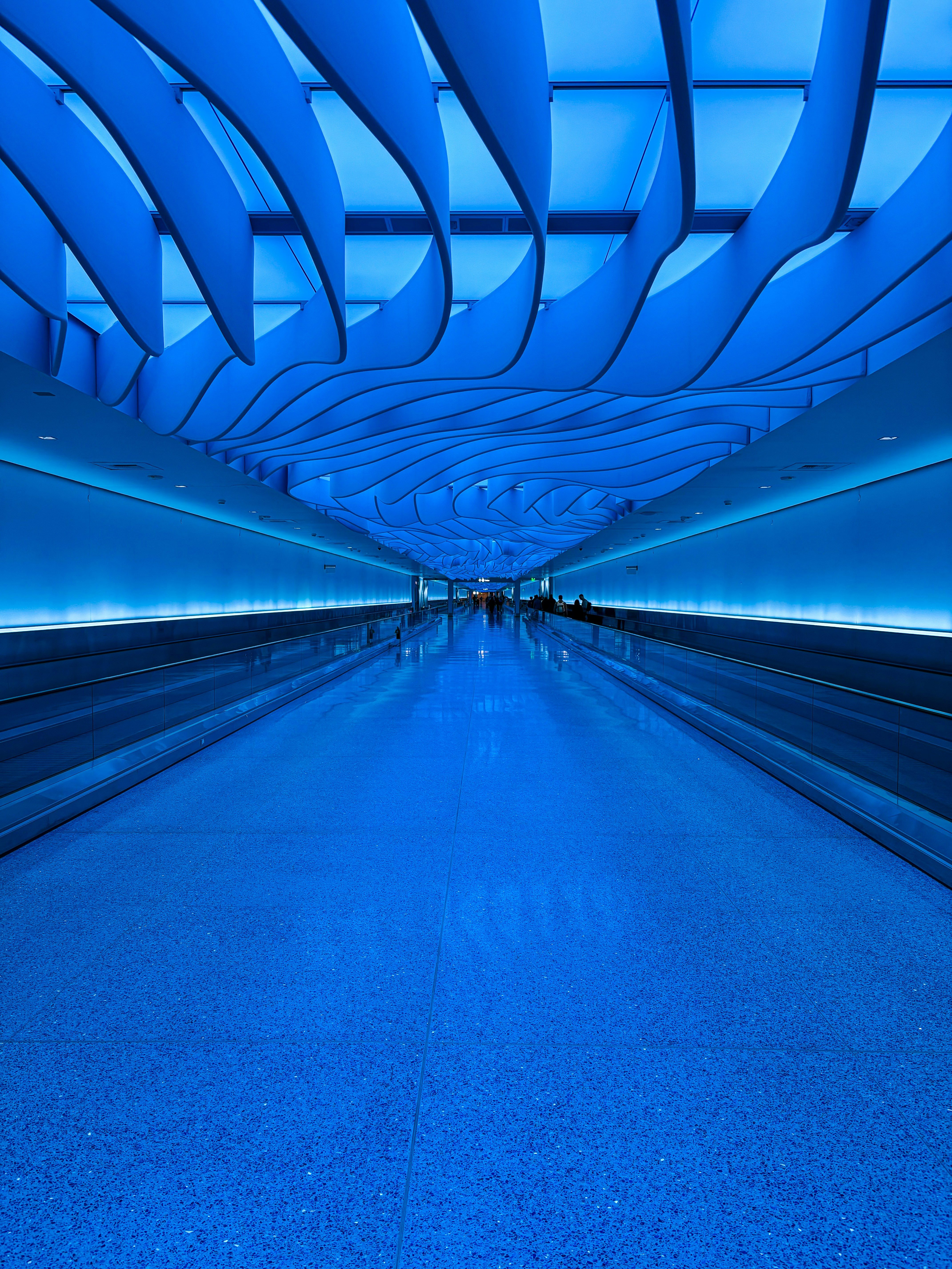Blue illuminated airport corridor