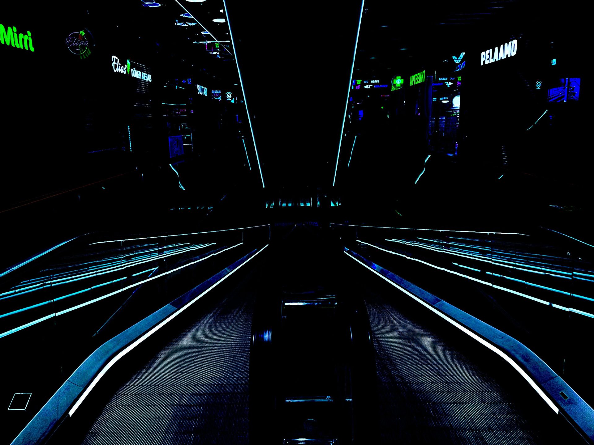 a train station at night with the lights on