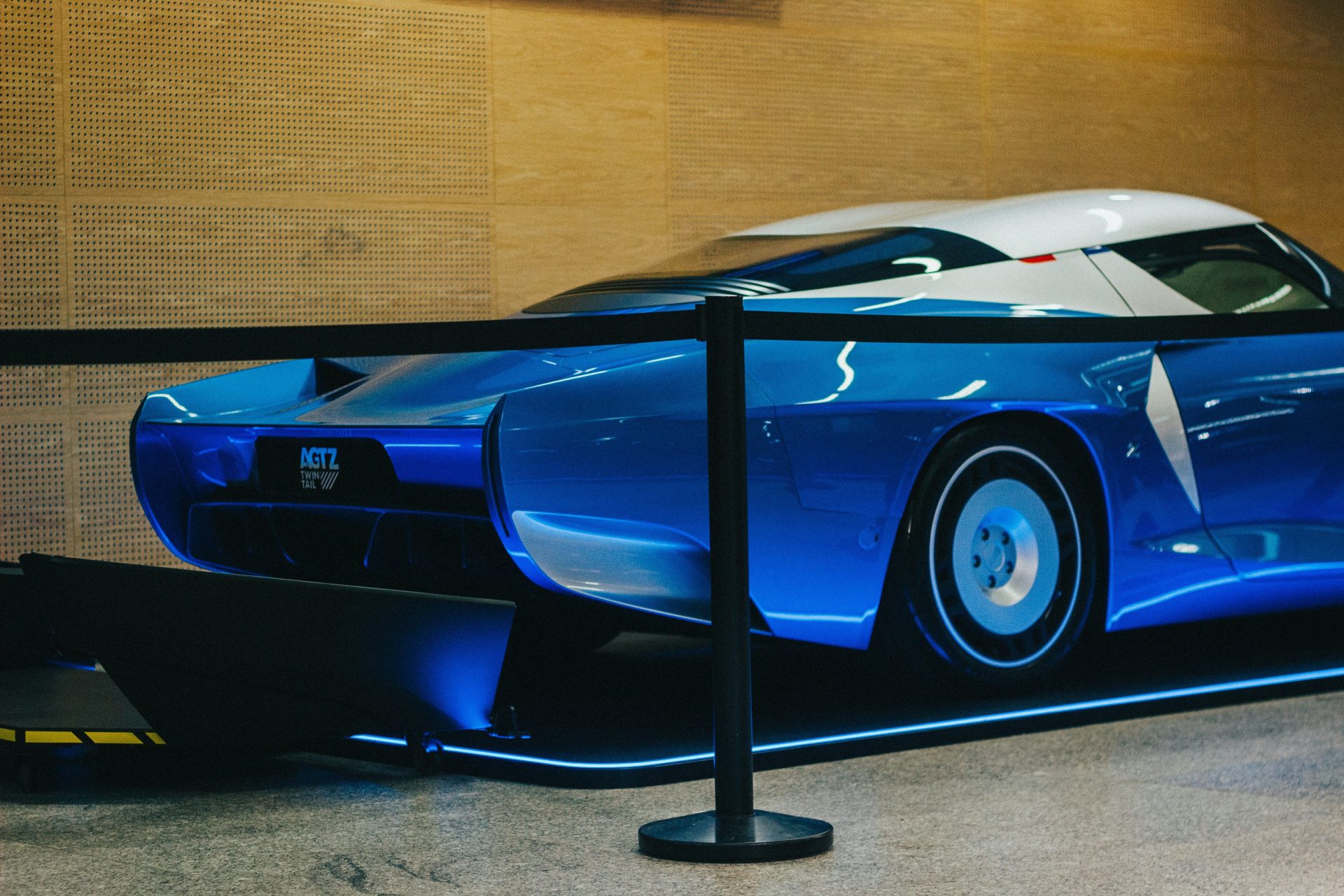 A futuristic blue and white sports car on display.